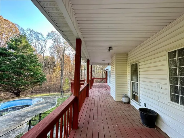 a view of balcony with wooden floor and outdoor seating