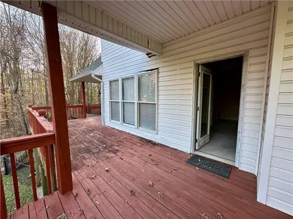 a view of a porch with wooden floor and stairs