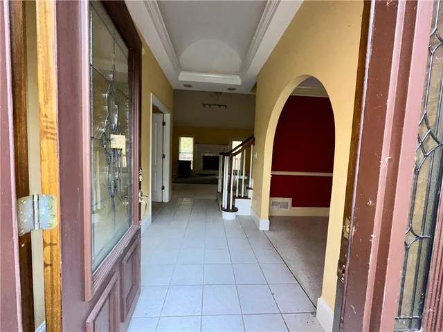a view of a hallway with furniture and a window
