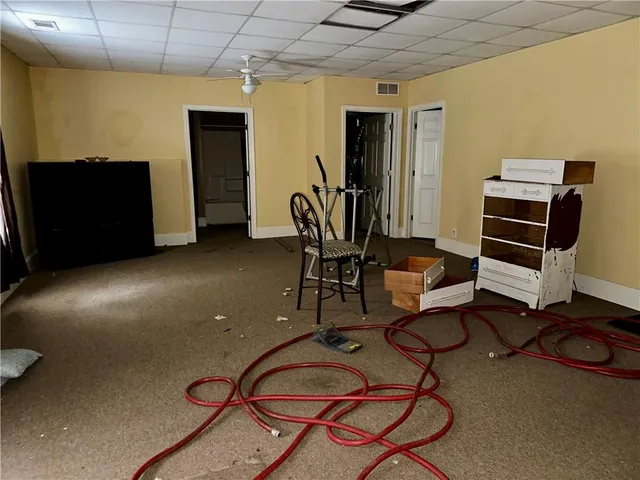 a view of a livingroom with furniture and gym equipment