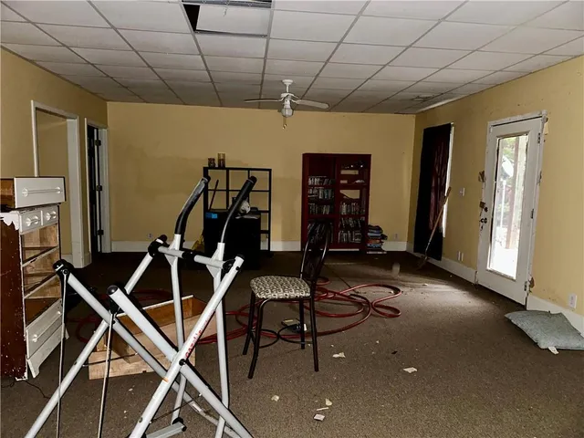 a room with gym equipment and windows