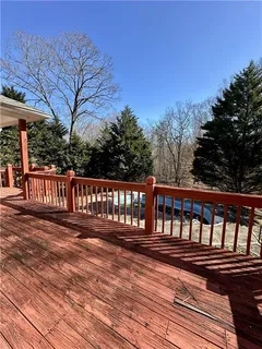 a view of a yard with wooden fence