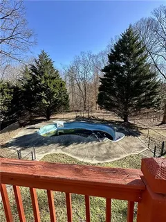 a view of balcony with wooden floor and seating space