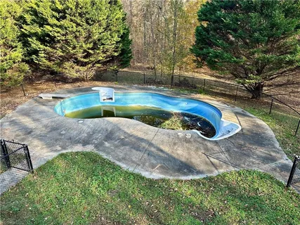 a view of a swimming pool with lounge chairs