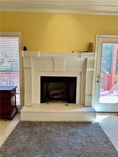 a living room with a fireplace and a rug