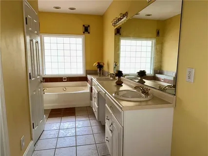 a bathroom with a sink a bathtub and a shower