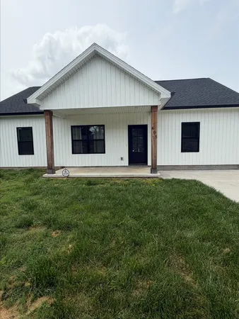 a front view of house with yard and green space