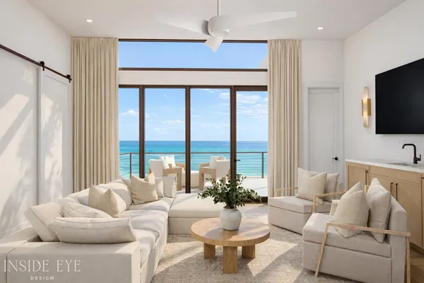 a living room with furniture a flat screen tv and a large window