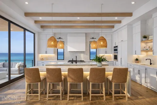 a dining area with a table chairs and a kitchen view