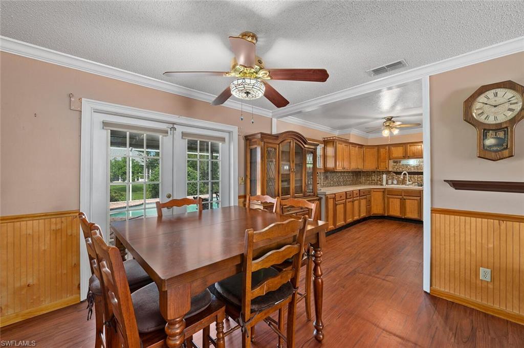 17520 Duquesne Road Fort Myers, FL 33967 - Photo 11 of 26 a view of a dining room with furniture window and wooden floor