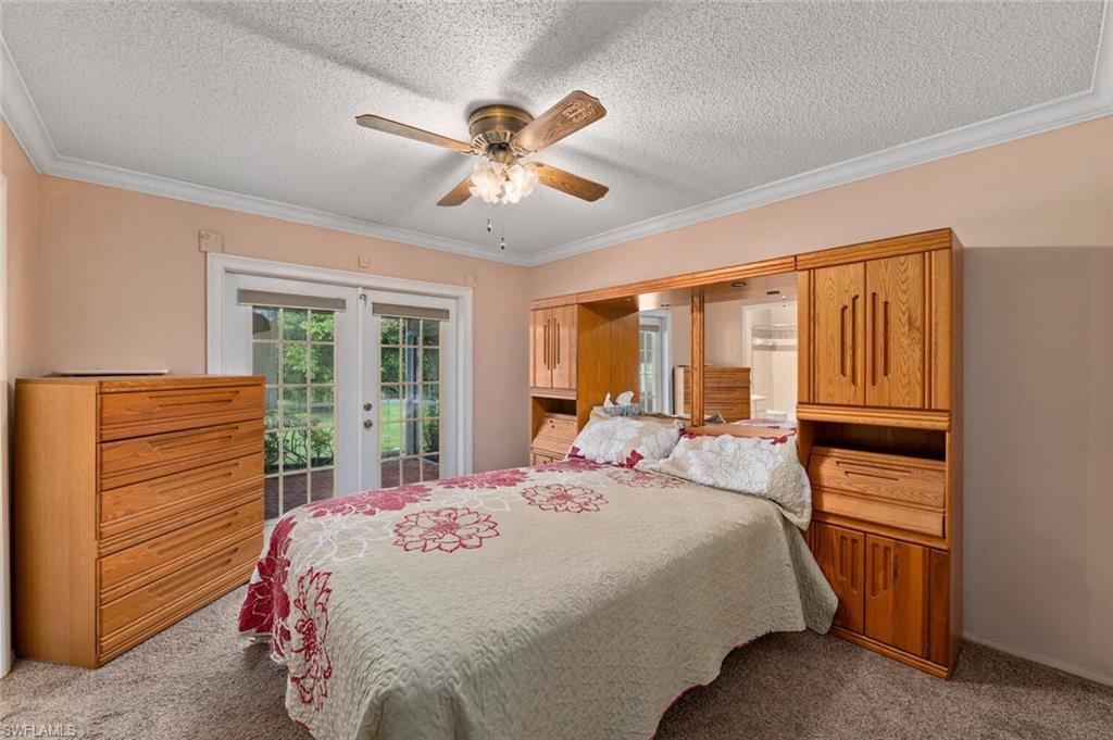 17520 Duquesne Road Fort Myers, FL 33967 - Photo 17 of 26 a bedroom with a bed and with furniture