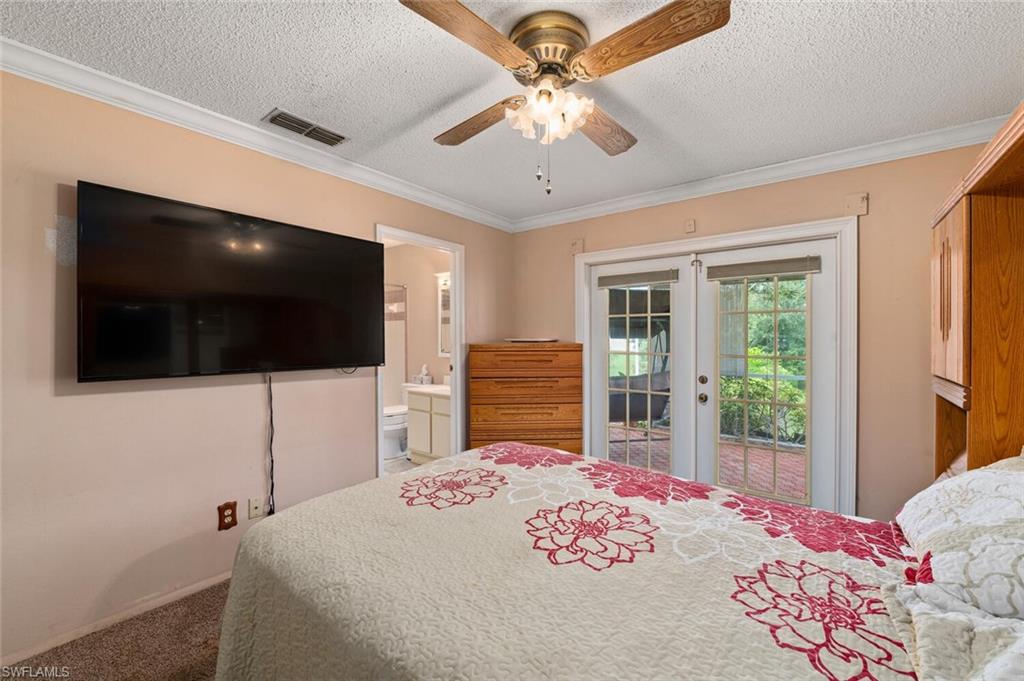 17520 Duquesne Road Fort Myers, FL 33967 - Photo 18 of 26 a bedroom with a bed and a flat screen tv