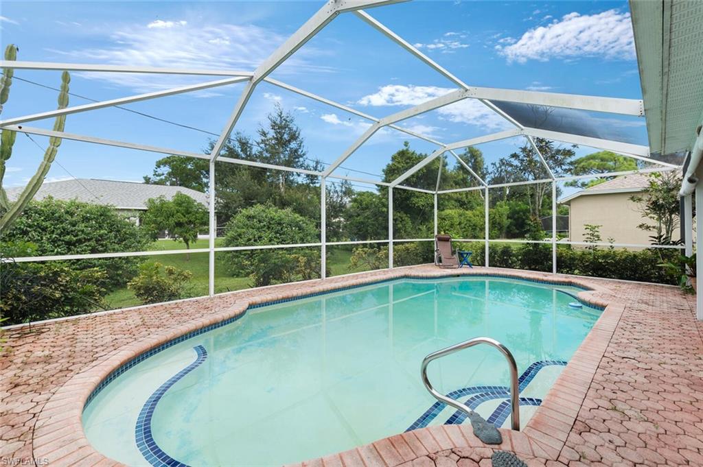 17520 Duquesne Road Fort Myers, FL 33967 - Photo 3 of 26 a view of a swimming pool with a garden