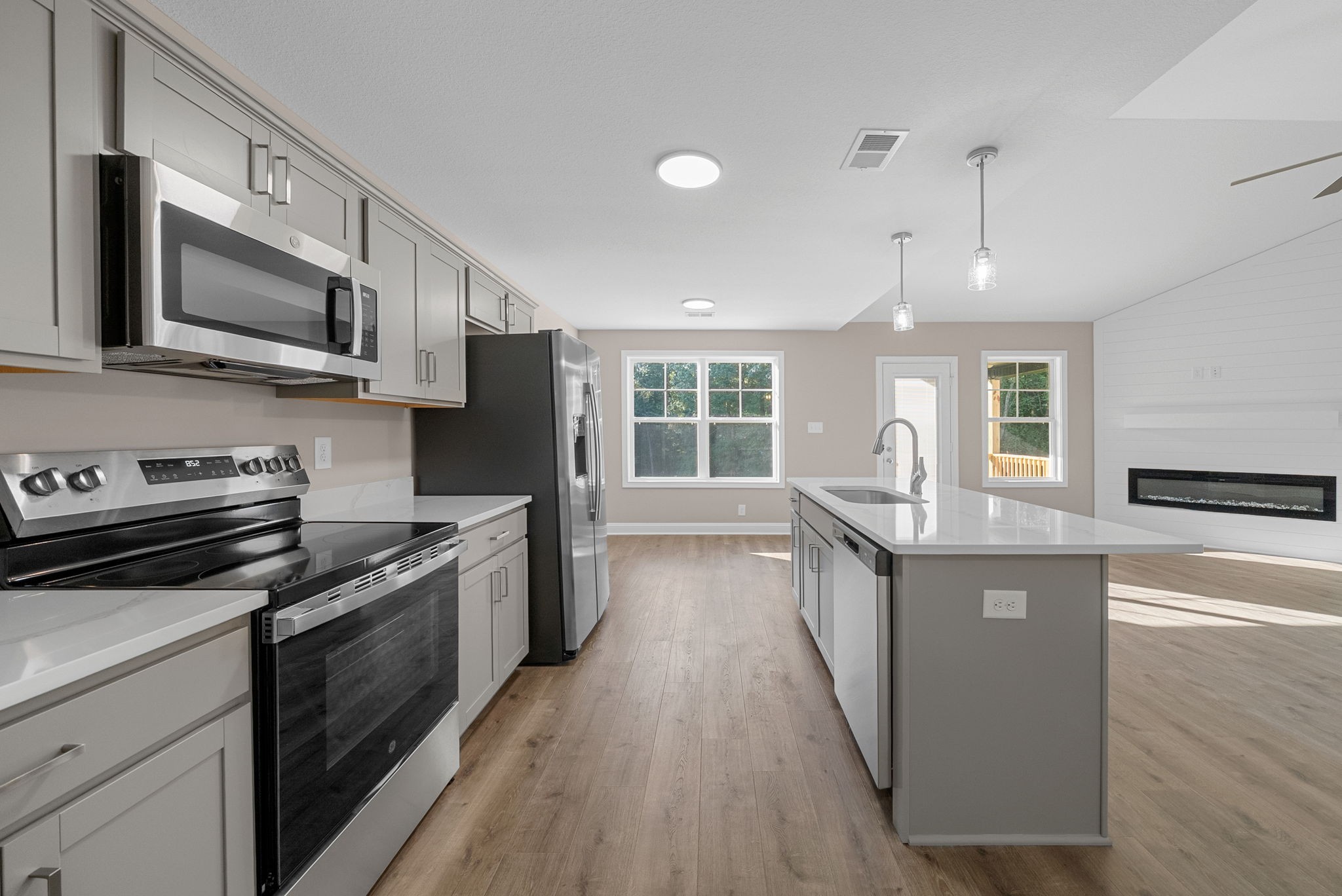 39 Echo Ridge Oak Grove, KY 42262 - Photo 12 of 28 a kitchen with stainless steel appliances kitchen island granite countertop a stove a sink and a microwave