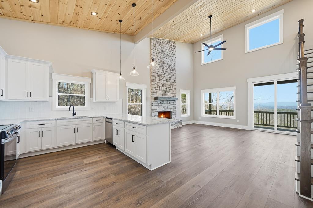 1176 Jewel Court Northeast Ranger, GA 30734 - Photo 11 of 57 a large kitchen with kitchen island wooden floors and stainless steel appliances