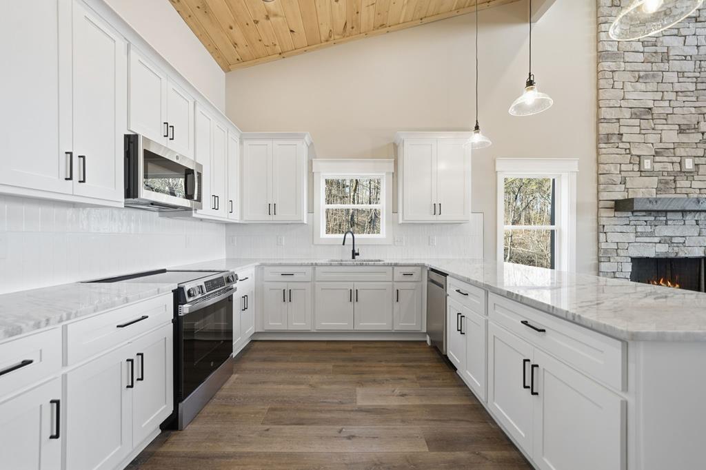 1176 Jewel Court Northeast Ranger, GA 30734 - Photo 15 of 57 a large white kitchen with cabinets
