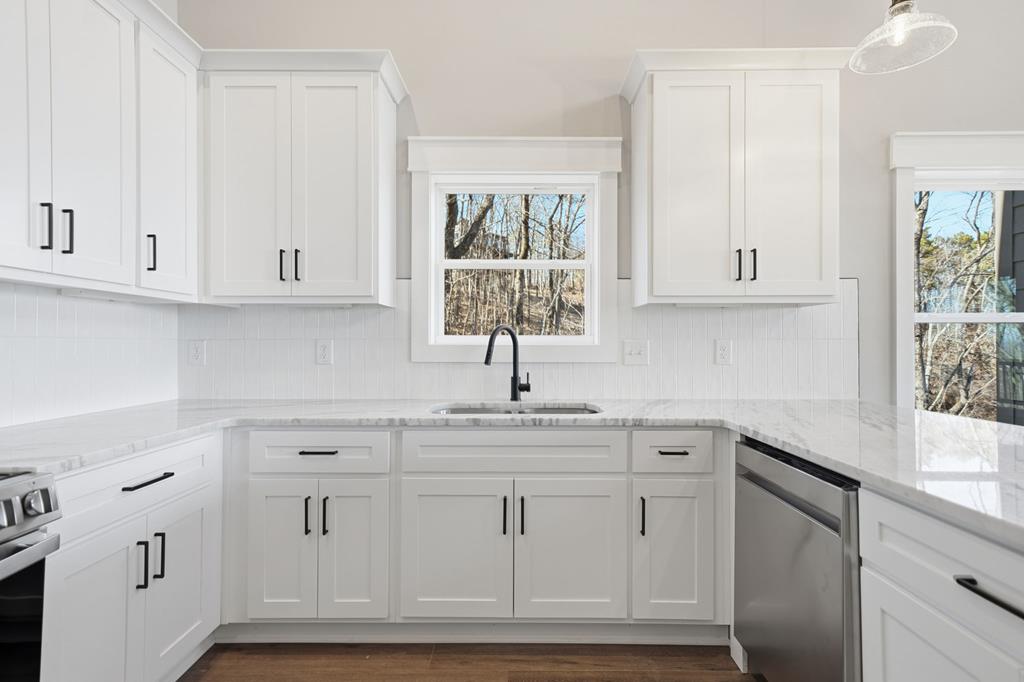 1176 Jewel Court Northeast Ranger, GA 30734 - Photo 16 of 57 a kitchen with white cabinets and a window