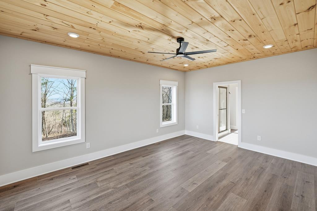 1176 Jewel Court Northeast Ranger, GA 30734 - Photo 21 of 57 a view of an empty room with a window and wooden floor