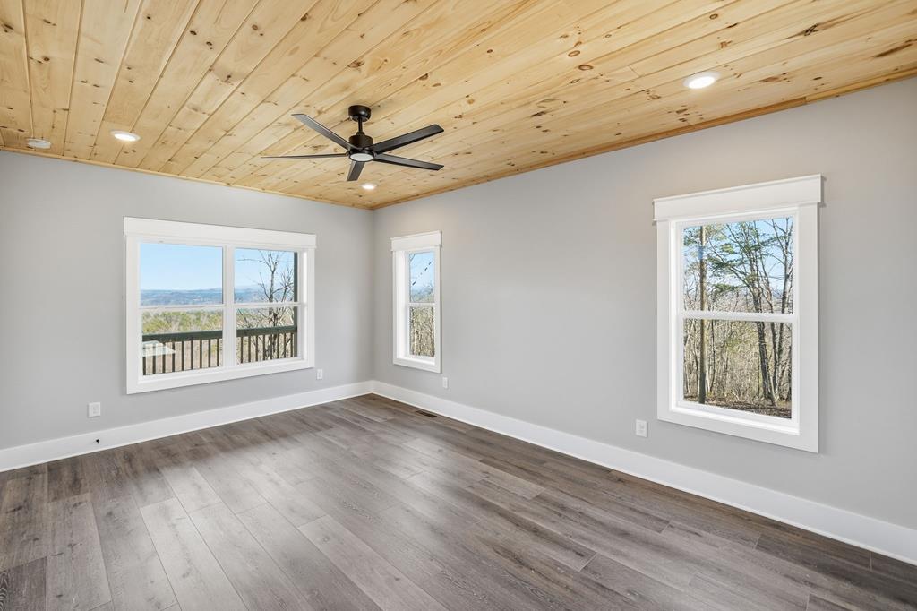 1176 Jewel Court Northeast Ranger, GA 30734 - Photo 23 of 57 a view of an empty room with a window and wooden floor