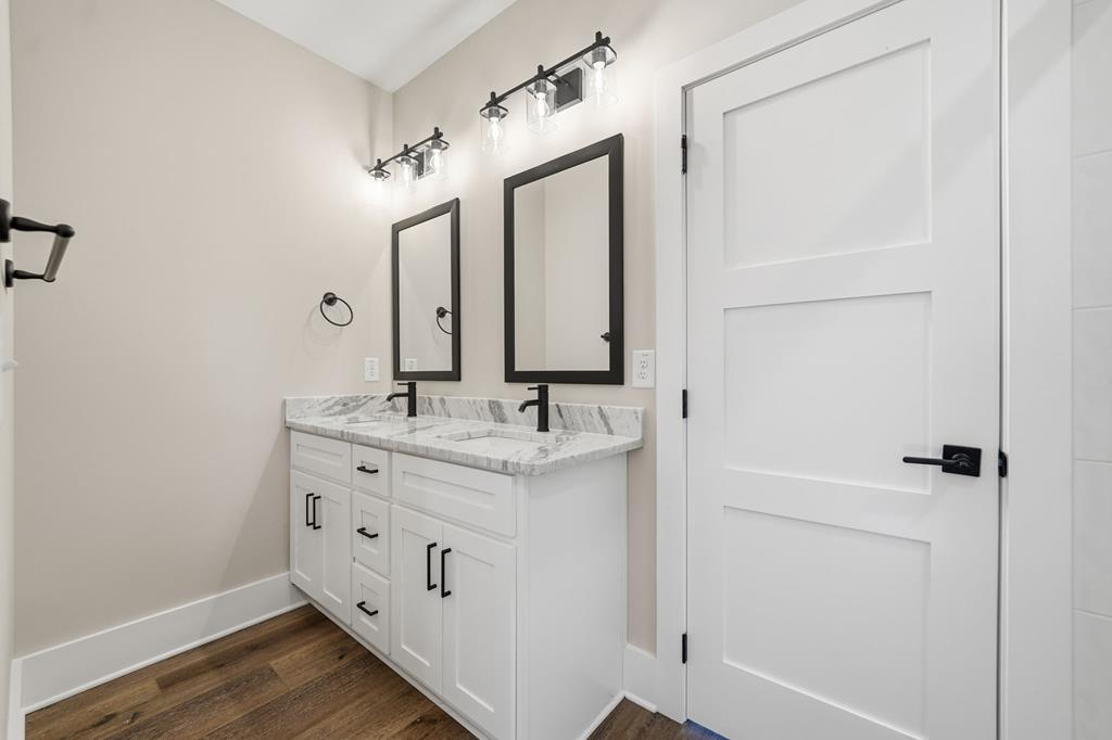 1176 Jewel Court Northeast Ranger, GA 30734 - Photo 27 of 57 a bathroom with a double vanity sink and a mirror