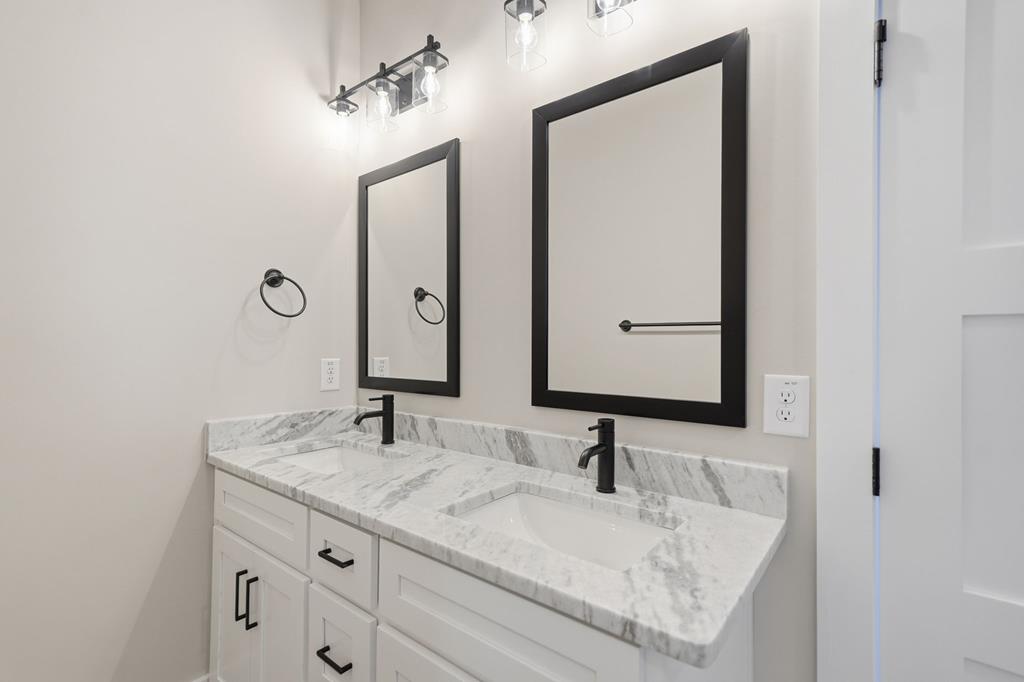 1176 Jewel Court Northeast Ranger, GA 30734 - Photo 28 of 57 a bathroom with a granite countertop sink and a mirror