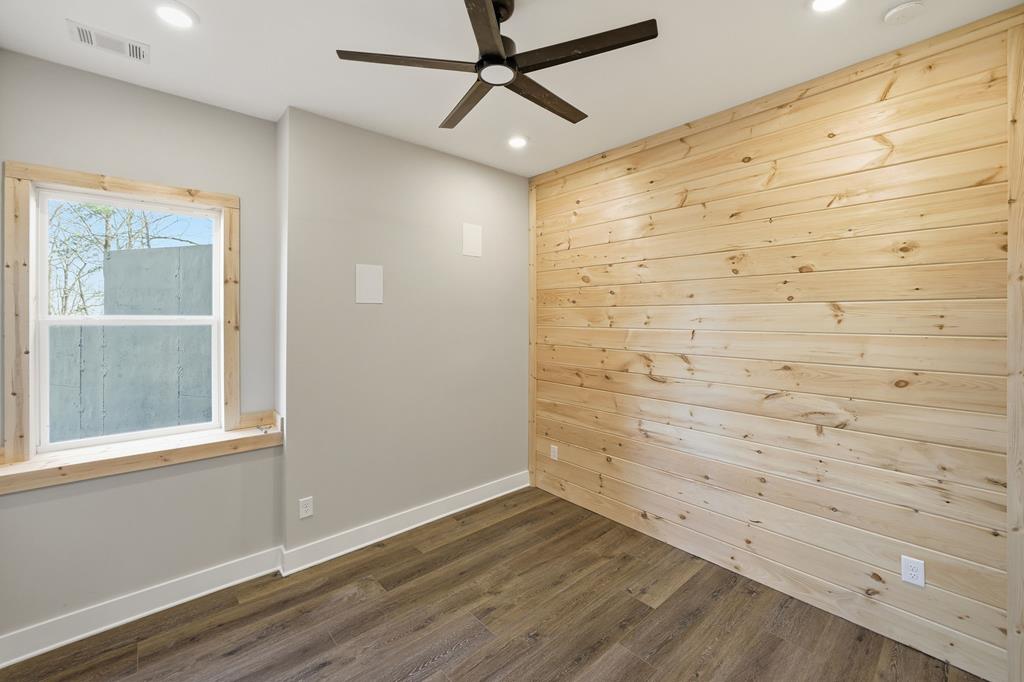 1176 Jewel Court Northeast Ranger, GA 30734 - Photo 37 of 57 a view of empty room with wooden floor and fan