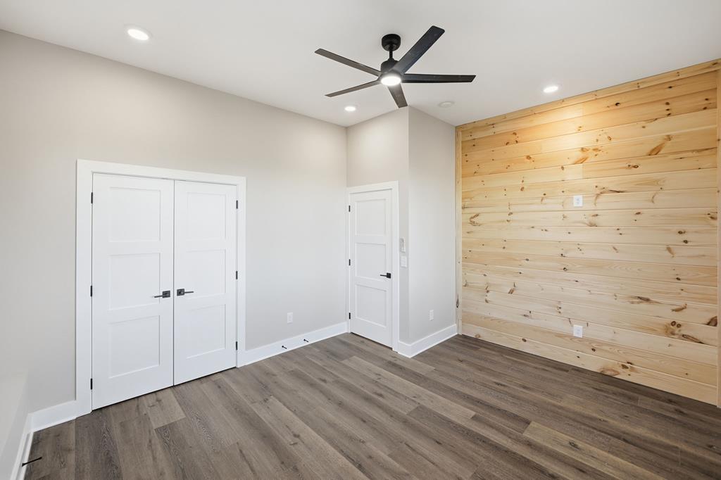 1176 Jewel Court Northeast Ranger, GA 30734 - Photo 40 of 57 an empty room with wooden floor and a ceiling fan