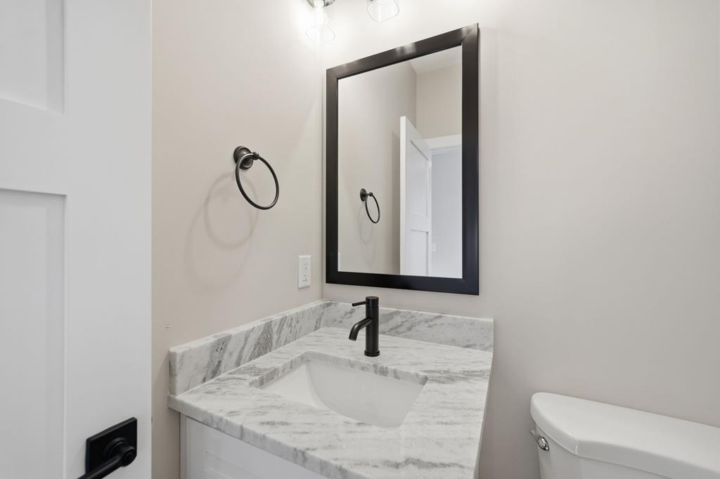 1176 Jewel Court Northeast Ranger, GA 30734 - Photo 10 of 57 a bathroom with a granite countertop sink and a mirror