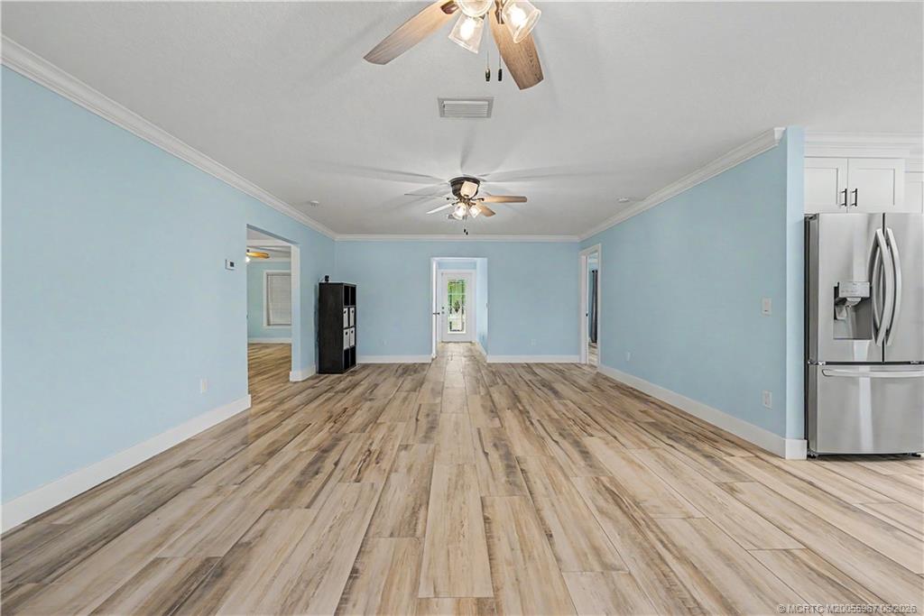 8200 Southwest Springhaven Avenue Indiantown, FL 34956 - Photo 22 of 35 a view of a livingroom with a chandelier fan