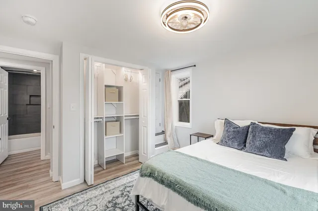 a bedroom with a bed and a window