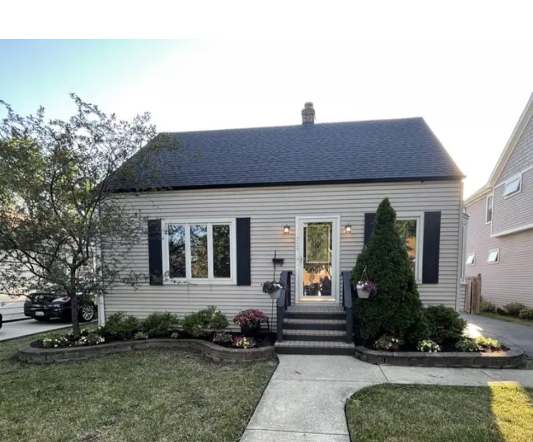 a front view of a house with garden