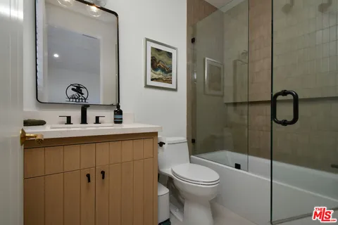 a bedroom with bed and a potted plant