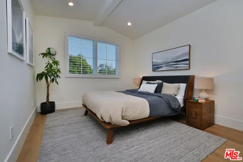 a bathroom with a granite countertop toilet sink and mirror