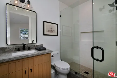 a white bed sitting in a spacious bedroom next to a window