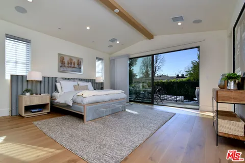 a spacious bathroom with a sink and a large mirror
