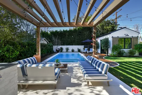 a patio with yard table and chairs