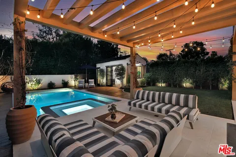 a view of swimming pool with seating area and furniture