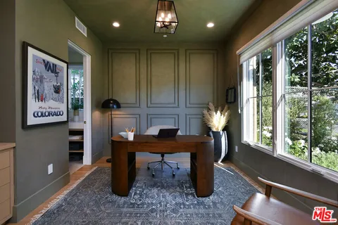 a living room with furniture and a painting