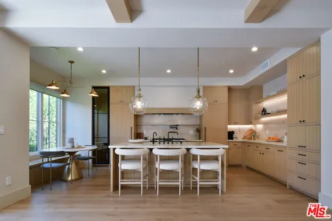 a kitchen with stainless steel appliances granite countertop a sink stove and cabinets
