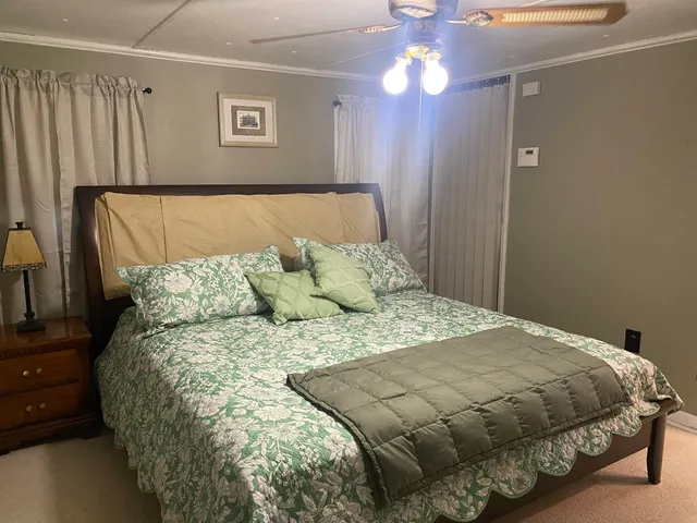 a spacious bedroom with a bed and a television