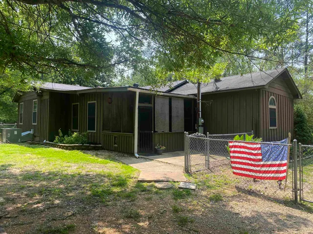 a front view of house with yard outdoor seating and barbeque oven