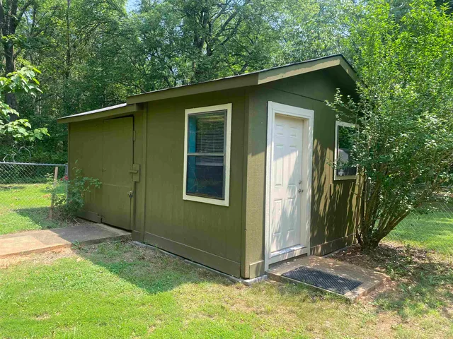 a view of patio with a table and chairs under an umbrella