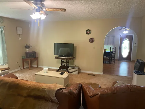 a living room with furniture and a book shelf