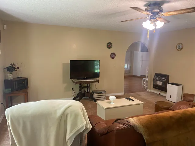 a view of a livingroom with furniture and a chandelier