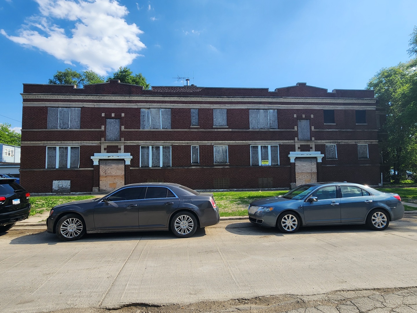 4921 West Maypole Avenue Chicago, IL 60644 - Photo 3 of 3 a car parked in front of a white building