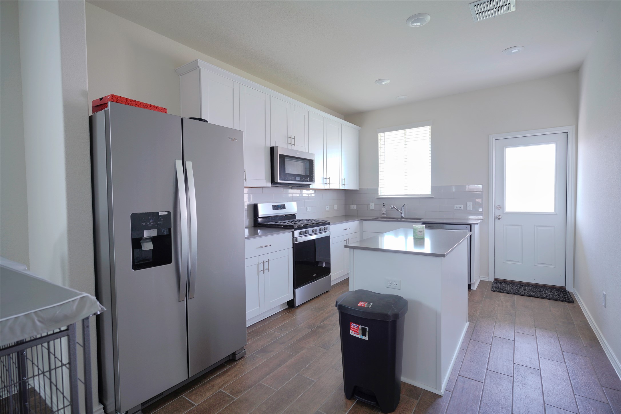 545 Tree Nut Loop Buda, TX 78610 - Photo 3 of 19 Gleaming stone countertops and modern appliances define this thoughtfully designed kitchen layout.