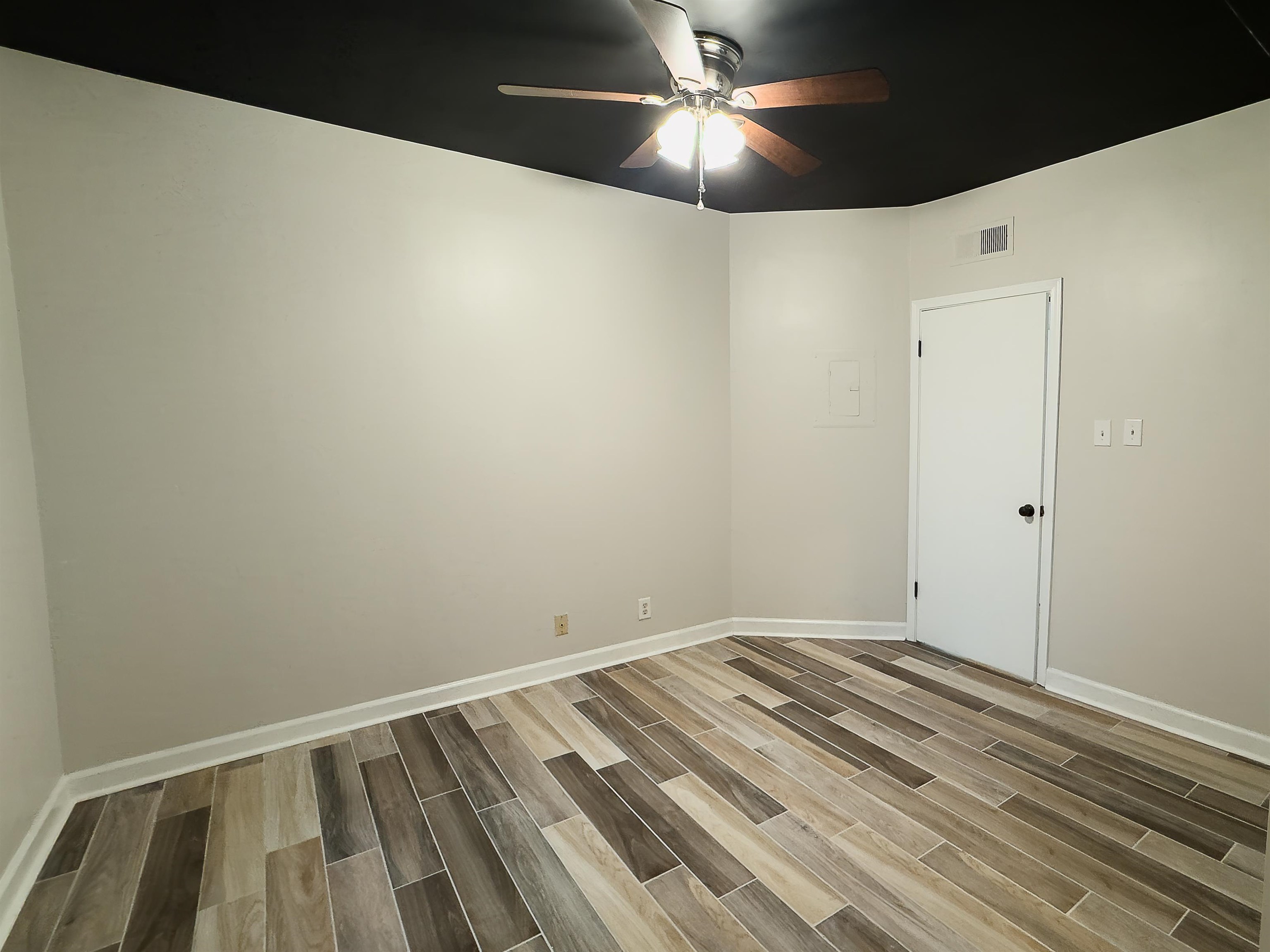109 North Main Street, Unit 907 Memphis, TN 38103 - Photo 15 of 29 Room with wood-finish plank flooring, white baseboards, and light-toned walls