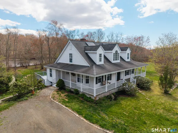 a aerial view of a house with a garden and lake view