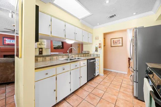 a dining room with furniture and large windows