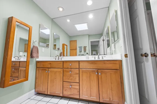 a bathroom with a sink mirror vanity and toilet